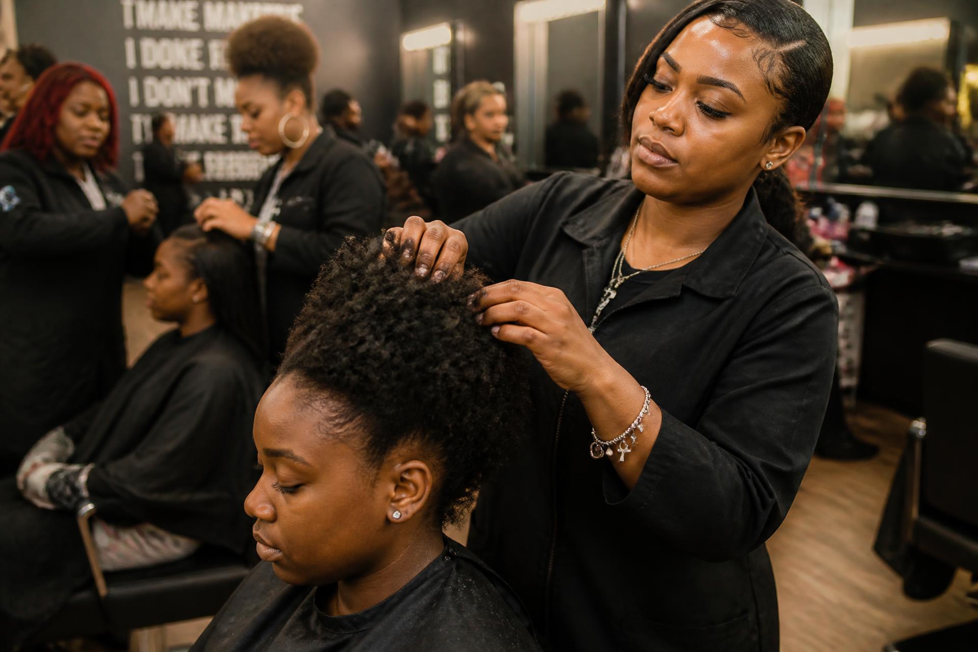 Cosmetology students practicing hair styling techniques at Beyond Beauty Academy in Hampton, Virginia
